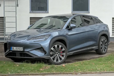 A BYD Sealion electric SUV on a busy urban street representing the Chinese automaker's record overseas sales surge driven by rising global oil prices in 2026.