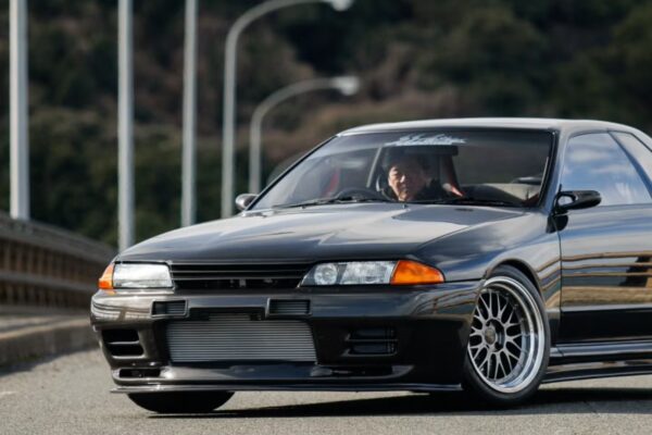 Garage Active's full dry carbon narrowbody Nissan Skyline R32 GT-R parked in Japan, showing the raw carbon fibre bodywork and narrow factory-width proportions of the $375,000 commission build.