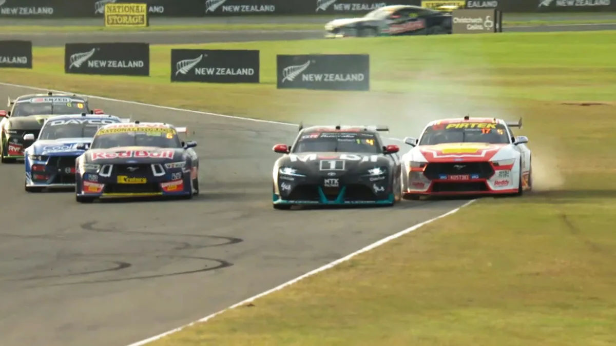 Chaz Mostert's #1 Toyota GR Supra and Brodie Kostecki's #17 Shell V-Power Ford Mustang making side-by-side contact at Ruapuna Raceway during the 2026 ITM Christchurch Super 440, with dust rising from the infield.