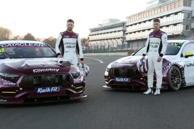 Jason Plato's purple and white Mercedes-AMG A35 BTCC race cars for Plato Racing's debut 2026 season, photographed in the team's Wellingborough workshop next to RML's facility.