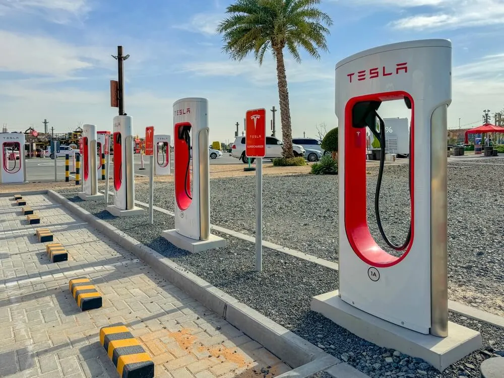 A Tesla Supercharger station at a commercial centre in Dubai, UAE, representing the company's expanding Gulf infrastructure now under threat from Iran's IRGC.