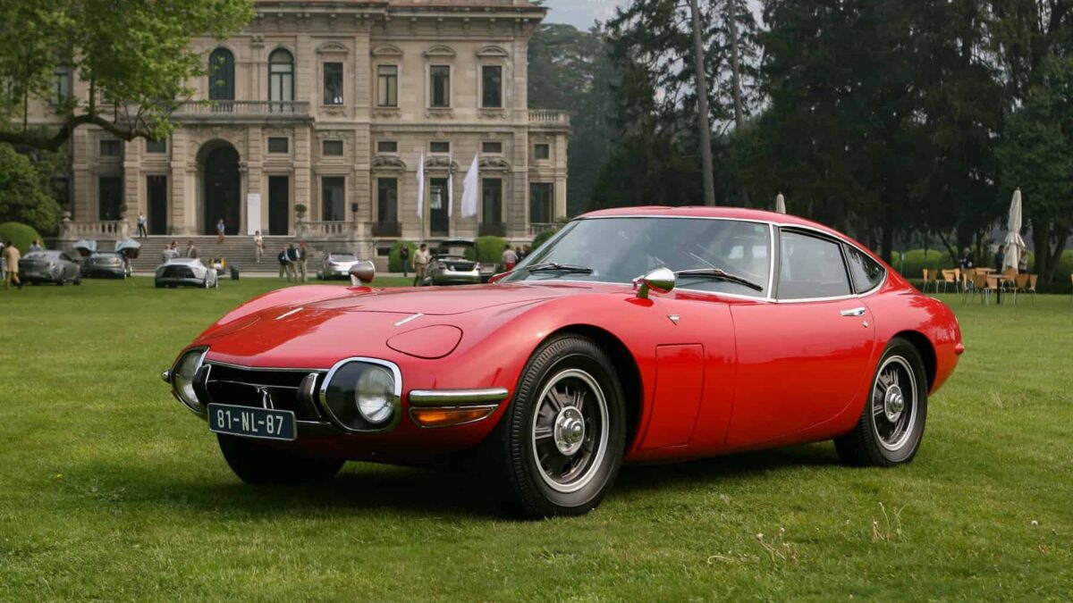 A red Toyota 2000GT from 1967, widely considered Japan's first true supercar, co-developed with Yamaha from a project originally intended for Nissan