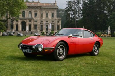 A red Toyota 2000GT from 1967, widely considered Japan's first true supercar, co-developed with Yamaha from a project originally intended for Nissan