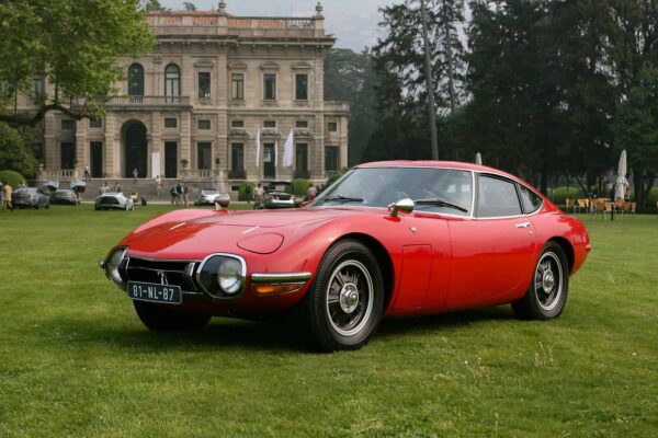 A red Toyota 2000GT from 1967, widely considered Japan's first true supercar, co-developed with Yamaha from a project originally intended for Nissan