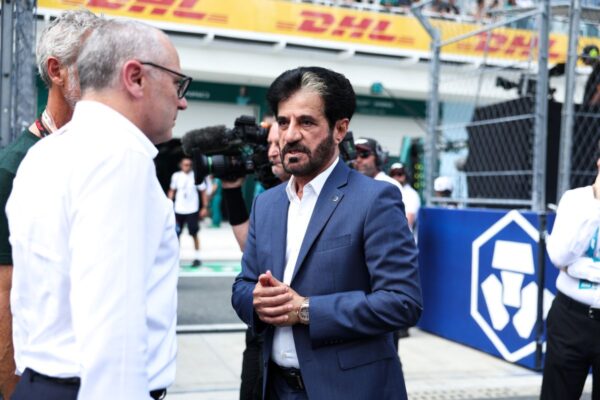 FIA president Mohammed Ben Sulayem speaking to media in the Miami Grand Prix paddock, with a 2026 Formula 1 power unit visible in the background.
