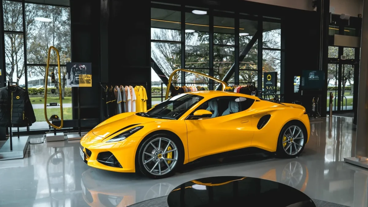 A Lotus Emira sports car parked at the Lotus factory in Hethel, Norfolk, representing the model that will switch to a new hybrid V6 powertrain alongside a revived Esprit V8 supercar.