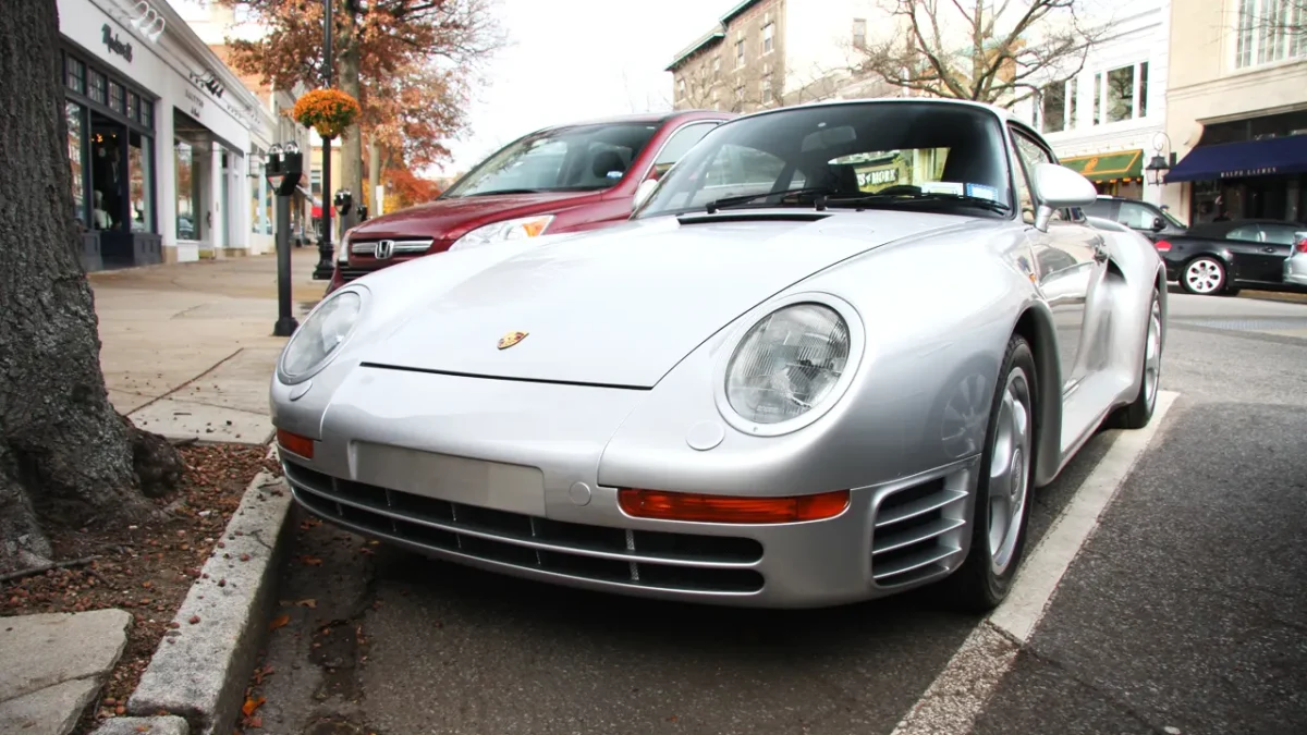 A silver Porsche 959 road car from 1986, the year it was unveiled, showing the wide-body aerodynamic design developed originally for Group B rally competition