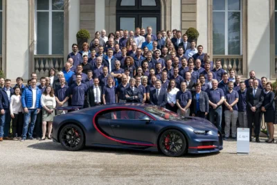 A Bugatti Chiron parked outside the brand's Molsheim factory in France, representing Porsche's divestment of its Bugatti Rimac stake to a private equity consortium.