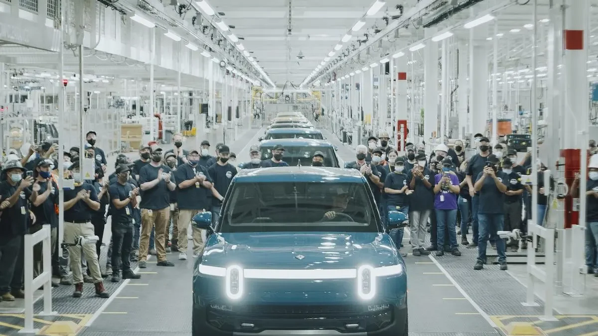 A Rivian R2 electric SUV on the production line at the Normal, Illinois factory, representing the start of volume production in April 2026 ahead of customer deliveries in June.