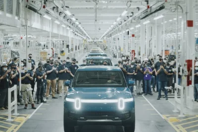 A Rivian R2 electric SUV on the production line at the Normal, Illinois factory, representing the start of volume production in April 2026 ahead of customer deliveries in June.