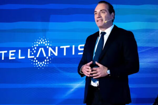 Stellantis CEO Antonio Filosa presenting the FaSTLAne 2030 strategic plan during the company's Investor Day at its North American headquarters in Auburn Hills, Michigan, with the new strategy slide visible behind him.