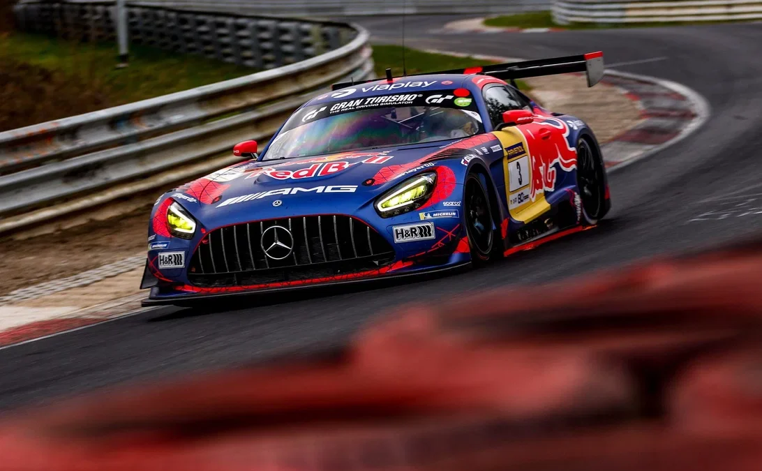 Max Verstappen's Red Bull-liveried #3 Mercedes-AMG GT3 racing through the Nordschleife at the 2026 Nürburgring 24 Hours