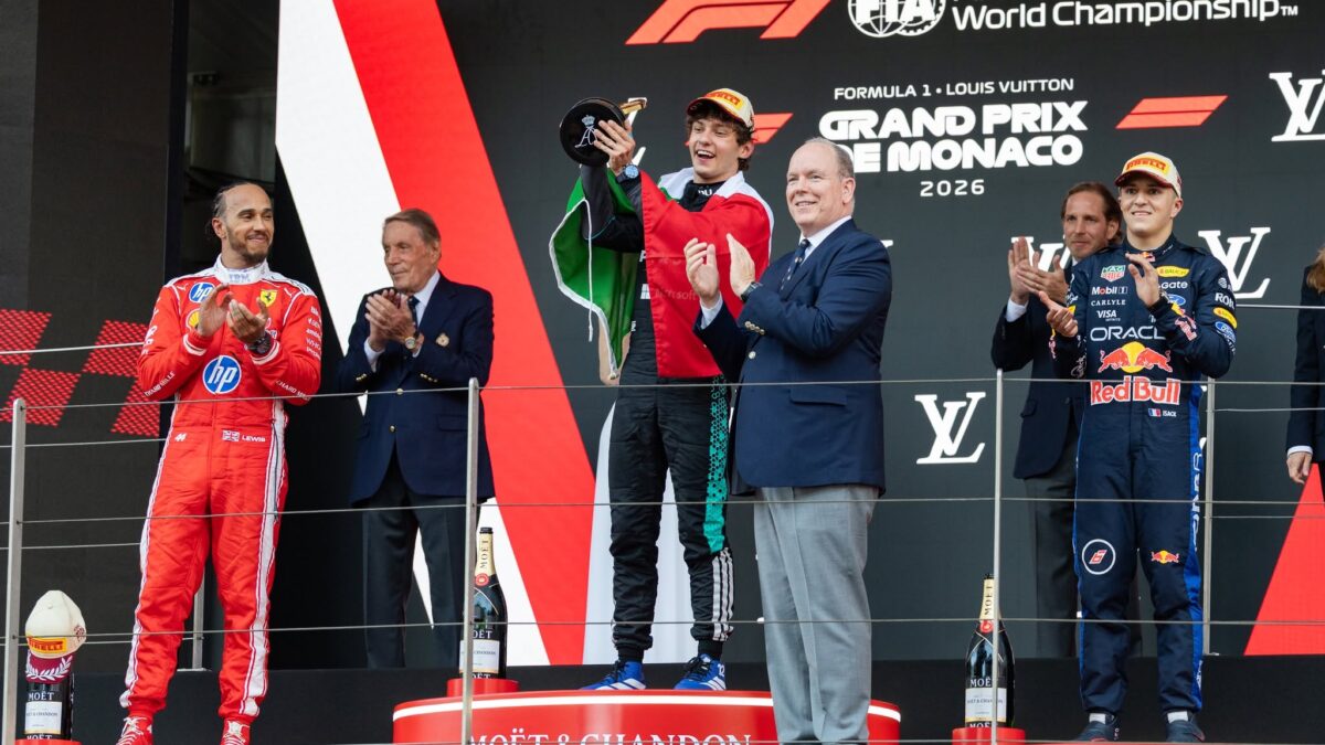 Kimi Antonelli celebrates on the Monaco Grand Prix podium with Lewis Hamilton beside him after becoming the youngest winner of the race in F1 history at 19 years and 9 months.