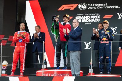 Kimi Antonelli celebrates on the Monaco Grand Prix podium with Lewis Hamilton beside him after becoming the youngest winner of the race in F1 history at 19 years and 9 months.