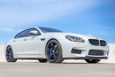 A 2015 BMW M6 Gran Coupe Competition in Space Gray with the rare six-speed manual transmission, one of only 103 manual M6 Gran Coupes ever built, parked on a clean urban street representing the ultimate sleeper enthusiast daily driver.