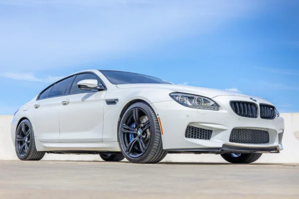 A 2015 BMW M6 Gran Coupe Competition in Space Gray with the rare six-speed manual transmission, one of only 103 manual M6 Gran Coupes ever built, parked on a clean urban street representing the ultimate sleeper enthusiast daily driver.