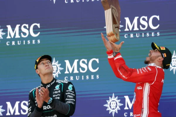 Lewis Hamilton celebrates on the podium with a Ferrari race suit after winning the 2026 Spanish Grand Prix at Barcelona-Catalunya — his first Grand Prix victory for the Italian team.