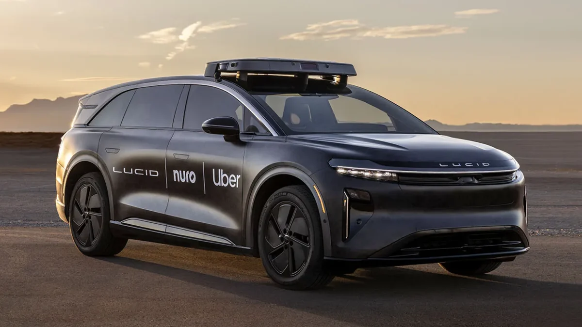 A Lucid Gravity SUV configured as an autonomous robotaxi with roof-mounted sensor halo containing lidar, cameras and radar, representing the Lucid-Nuro-Uber commercial robotaxi programme launching in San Francisco in 2026.