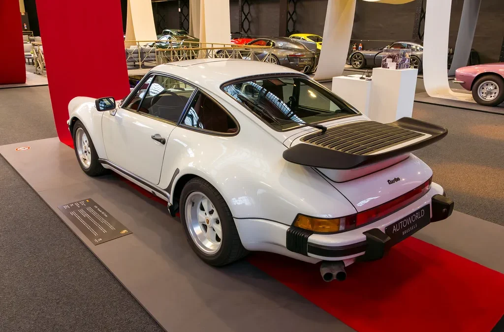 Classic air-cooled Porsche 911 rear three-quarter view showing the distinctive engine lid, illustrating Ferry Porsche's decision to keep the rear-engined layout against the advice of his own engineers
