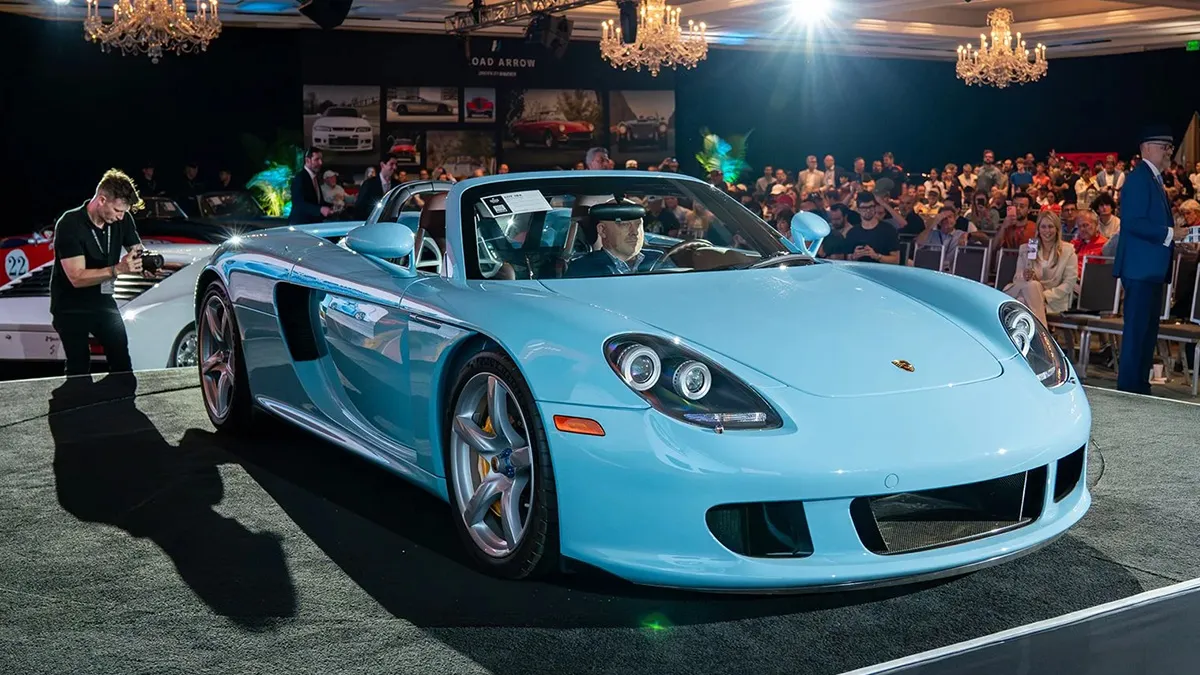 The Porsche Carrera GT Just Sold for $6.7 Million. Chris Harris Was Terrified of It at Ascari. 2 A paint-to-sample Gulf Blue Porsche Carrera GT on the Broad Arrow auction stage at Amelia Island 2026, surrounded by a packed crowd of bidders and spectators, the car that sold for a record $6.715 million — the highest price ever achieved at public auction for the model.